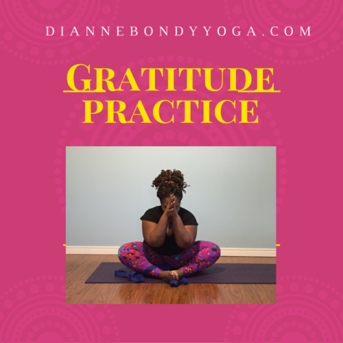 Dianne Bondy bows her head with hands touching in front of her forehead as she sits in baddha konasana.