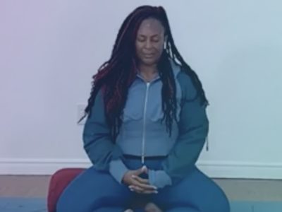 Dianne sits in seated meditation.